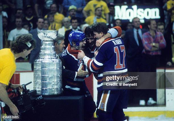 Mark Messier of the Edmonton Oilers celebrates with teammates Kevin Lowe and Jari Kurri after Game 5 of the 1990 Stanley Cup Finals against the...