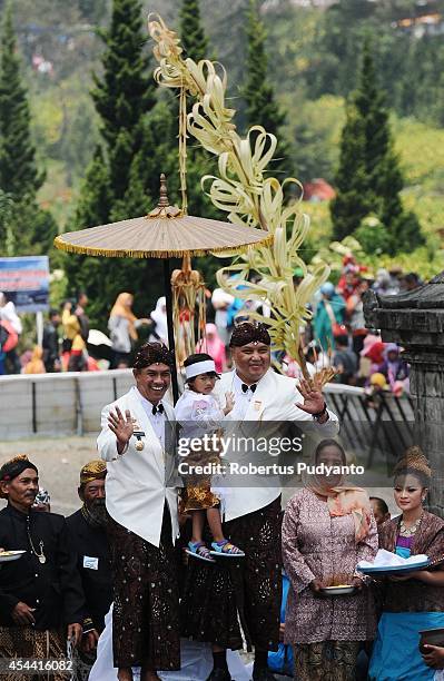 Young participants have their dreadlocked hair cut in the Ruwatan Rambut Gimbal ceremony during the Dieng Cultural Festival 2014 on August 31, 2014...