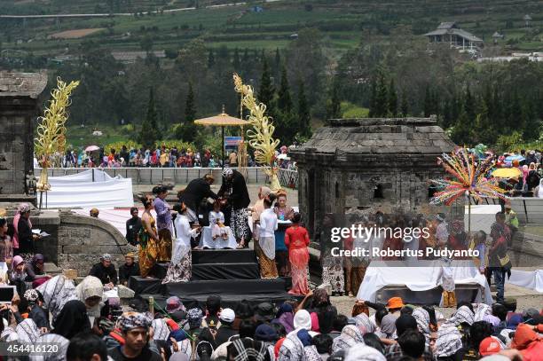 Young participants have their dreadlocked hair cut in the Ruwatan Rambut Gimbal ceremony during the Dieng Cultural Festival 2014 on August 31, 2014...