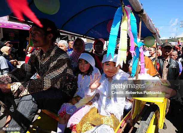 Dieng's dreadlock kids are paraded for the Ruwatan Rambut Gimbal ceremony on August 31, 2014 in Dieng, Java, Indonesia. The Dieng Culture Festival is...