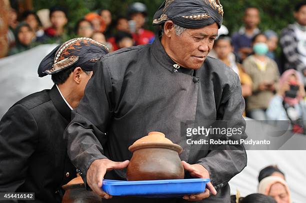 Dieng's religious leader attends to the Larung ritual as part of Ruwatan Rambut Gimbal ceremony on August 31, 2014 in Dieng, Java, Indonesia. The...