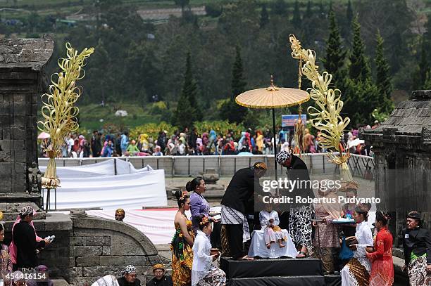 Young participants have their dreadlocked hair cut in the Ruwatan Rambut Gimbal ceremony during the Dieng Cultural Festival 2014 on August 31, 2014...