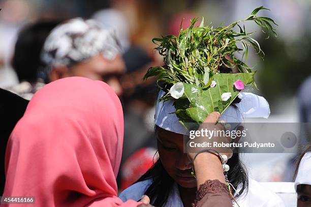 Child participates in the Jamasan ritual as part of Ruwatan Rambut Gimbal ceremony on August 31, 2014 in Dieng, Java, Indonesia. The Dieng Culture...