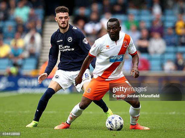 Scott Malone of Millwall tackles with Francois Zoko of Blackpool during the Sky Bet Championship match between Millwall and Blackpool at The Den on...