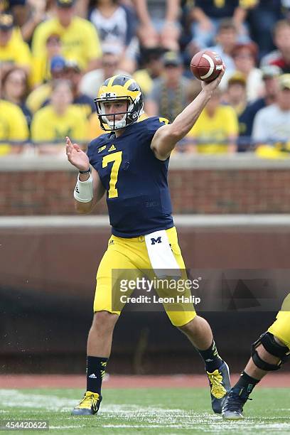 Quarterback Shane Morris of the Michigan Wolverines drops back to pass during the second half of the game against the Appalachian State Mountaineers...