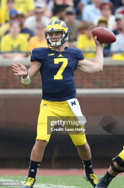 Quarterback Shane Morris of the Michigan Wolverines drops back to pass during the second half of the game against the Appalachian State Mountaineers...