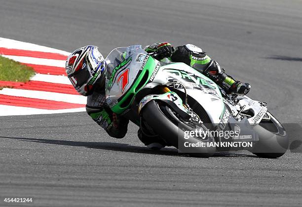 Drive M7 Aspar Japanese rider Hiroshi Aoyama turns a corner with his Honda during the MotoGP race at the motorcycling British Grand Prix at...