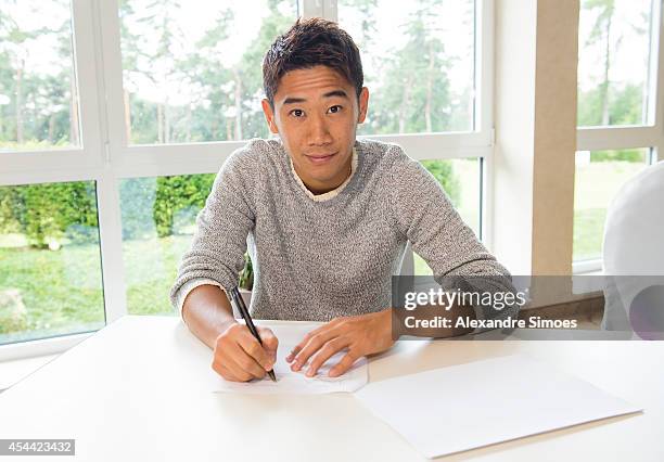 New signing Shinji Kagawa of Dortmund signs his new Borussia Dortmund contract on August 31, 2014 in Dortmund, Germany.