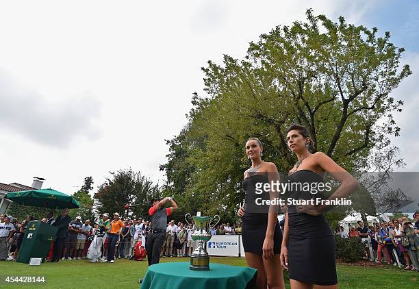 Francesco Molinari of Italy plays his tee shot as models wearing sponsors jewelley look on during the final round of the 71st Italian Open Damiani at...