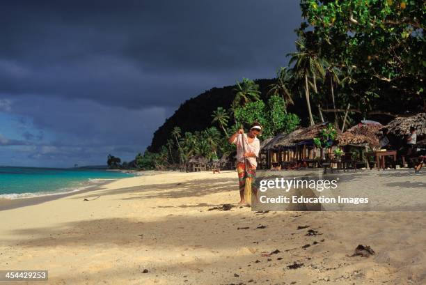 Western Samoa, Island Of Upolu, Lalomanu Samoan Woman Sweeping Beach.