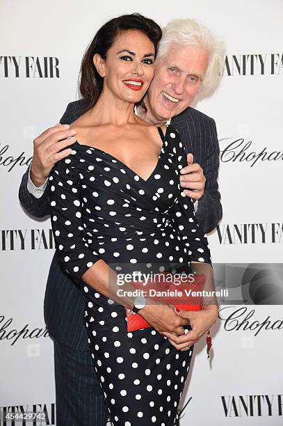 Maria Grazia Cucinotta and Douglas Kirkland attend the Chopard And Vanity Fair Present 'Backstage At Cinecitta' Exhibition - Red Carpet - 71st Venice...