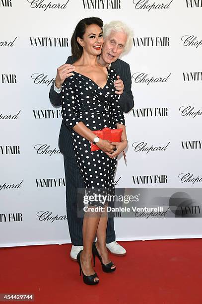 Maria Grazia Cucinotta and Douglas Kirkland attend the Chopard And Vanity Fair Present 'Backstage At Cinecitta' Exhibition - Red Carpet - 71st Venice...