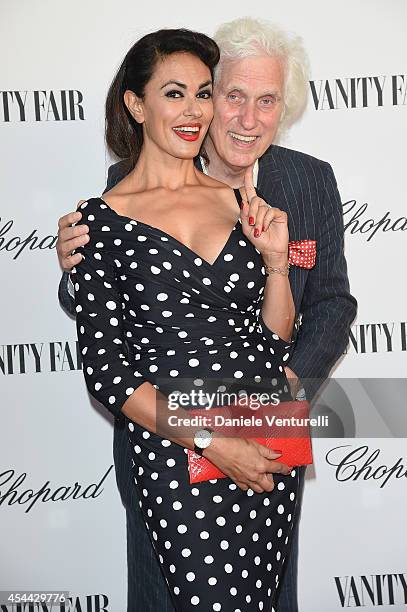 Maria Grazia Cucinotta and Douglas Kirkland attend the Chopard And Vanity Fair Present 'Backstage At Cinecitta' Exhibition - Red Carpet - 71st Venice...