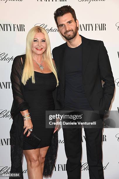 Monika Bacardi and Andrea Iervolino attend the Chopard And Vanity Fair Present 'Backstage At Cinecitta' Exhibition - Red Carpet - 71st Venice Film...