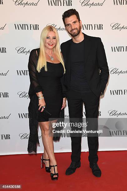 Monika Bacardi and Andrea Iervolino attend the Chopard And Vanity Fair Present 'Backstage At Cinecitta' Exhibition - Red Carpet - 71st Venice Film...