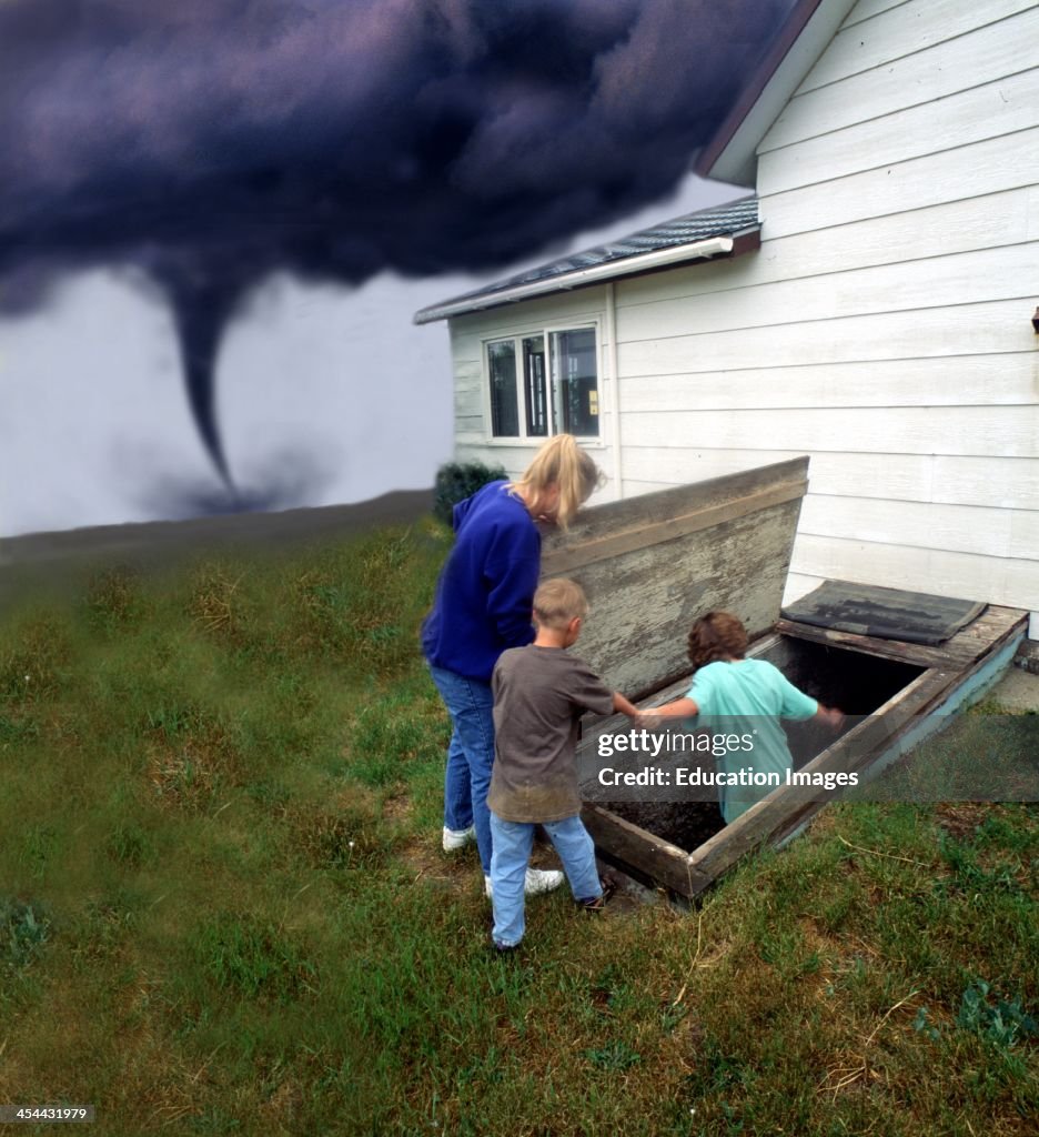 Avoidgone Family going into cellar to avoid Tornado. News Photo - Getty Images