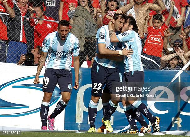 Diego Milito of Racing Club celebrates with his teammates after scoring the opening goal against Independiente during a match between Independiente...
