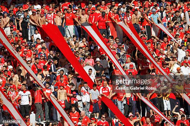 Fans of Independiente cheer for their team prior a match between Independiente and Racing as part of fifth round of Torneo de Transicion 2014 at...