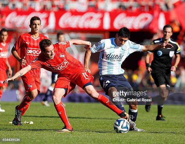Federico Mancuello of Independiente fights for the ball with Gaston Diaz of Racing Club during a match between Independiente and Racing as part of...