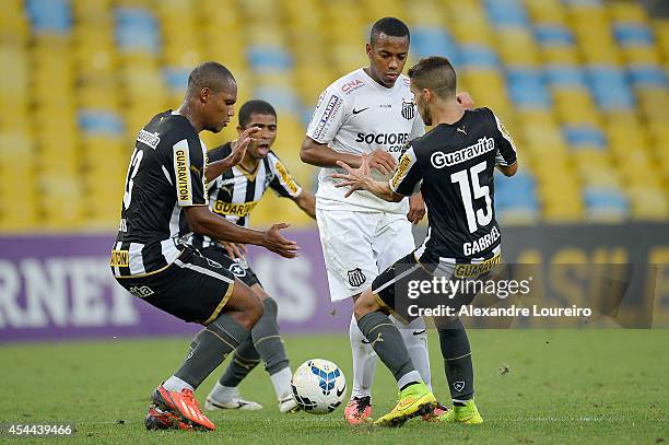 Andre Bahia , Junior Cesar and Gabriel of Botafogo battles for the ball with Robinho of Santos during the match between Botafogo and Santos as part...