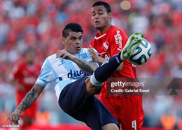 Luis Ibañez of Racing Club fights for the ball with Nestor Breitenbruch of Independiente during a match between Independiente and Racing as part of...