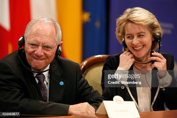 Bloomberg's Best Photos 2013: Wolfgang Schaeuble, Germany's finance minister, left, and Ursula von der Leyen, Germany's labor minister, smile during...