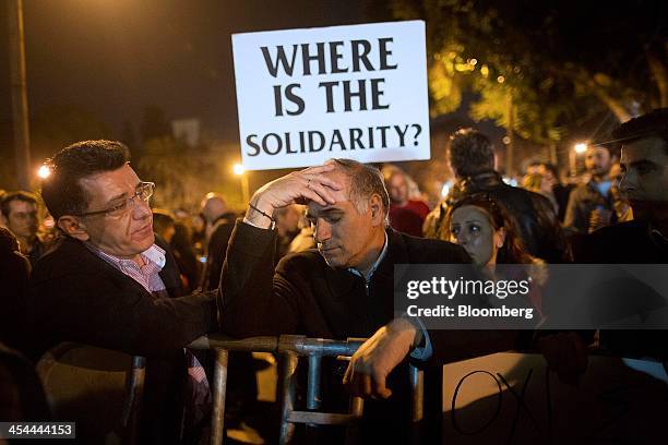 Bloomberg's Best Photos 2013: Demonstrator Gristakis Georgiou, an employee for Cyprus Popular Bank Pcl, center, reacts during a protest outside the...