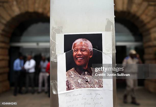 Photograph of Nelson Mandela is posted on a pole in front of the Union Buildings on December 9, 2013 in Pretoria, South Africa. Final preparations...