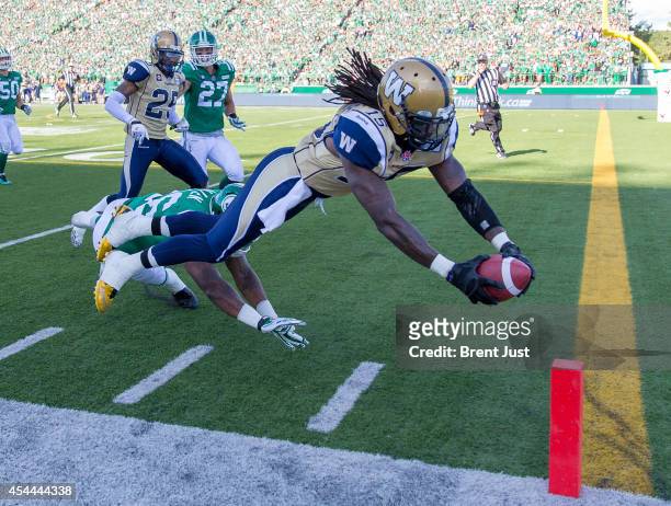 Troy Stoudermire of the Winnipeg Blue Bombers dives for a touchdown during a kick return in a game between the Winnipeg Blue Bombers and Saskatchewan...