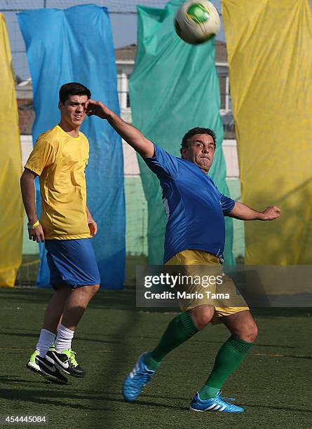 Presidential candidate Aecio Neves of the Brazilian Social Democracy Party kicks the ball during a campaign soccer match at the Zico Football Center...
