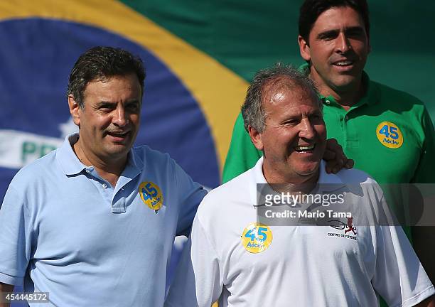 Presidential candidate Aecio Neves of the Brazilian Social Democracy Party walks with Zico as former volleyball player Giovane Gavio looks on at a...