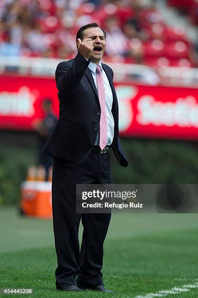 Carlos Bustos, head coach of Chivas, gives instructions to his players during a match between Chivas and Cruz Azul as part of Apertura 2014 Liga MX...