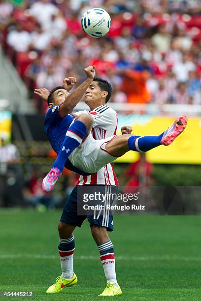 Jesus Sanchez of Chivas fights for the ball with Marco Fabian of Cruz Azul during a match between Chivas and Cruz Azul a as part of Apertura 2014...