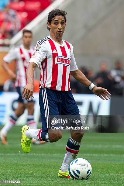 Fernando Arce of Chivas drives the ball during a match between Chivas and Cruz Azul a as part of Apertura 2014 Liga MX at Omnilife Stadium on August...