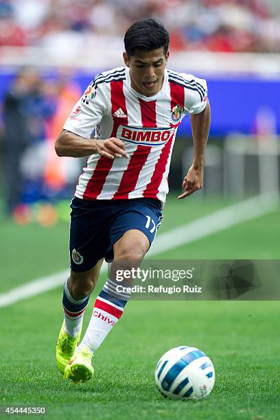 Jesus Sanchez of Chivas controls the ball during a match between Chivas and Cruz Azul a as part of Apertura 2014 Liga MX at Omnilife Stadium on...