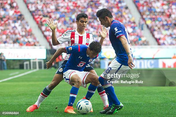 Alberto Garcia of Chivas fights for the ball with Joao Rojas of Cruz Azul during a match between Chivas and Cruz Azul a as part of Apertura 2014 Liga...