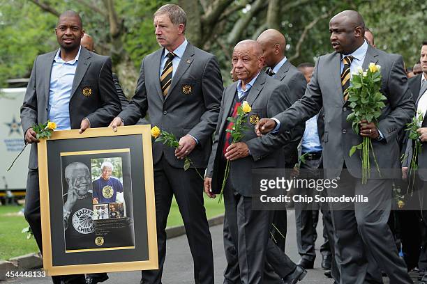 Members of the Kaiser Chiefs football club, including goalkeeper Itumeleng Khune and Coach Stuart William Baxter , arrive at the home of former South...