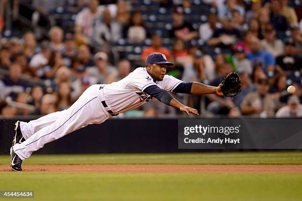 Chris Nelson of the San Diego Padres attempts to make a catch at third base in the game against the Milwaukee Brewers at Petco Park on August 25,...