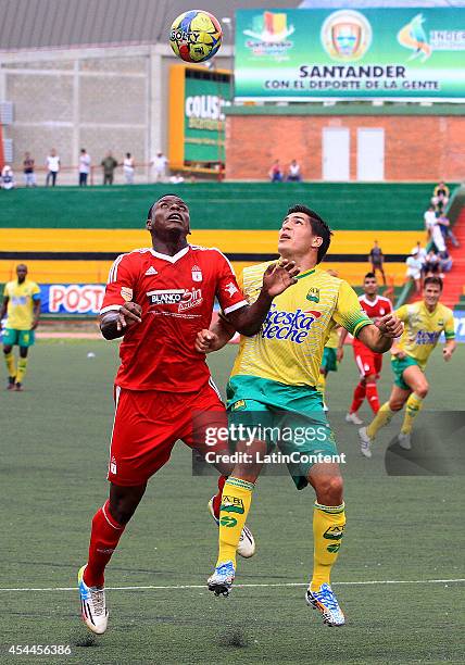 Arnold Palacios of America de Cali fights for the ball during a match between America de Cali and Bucaramanga as part of Torneo Postobon 2014 - II at...