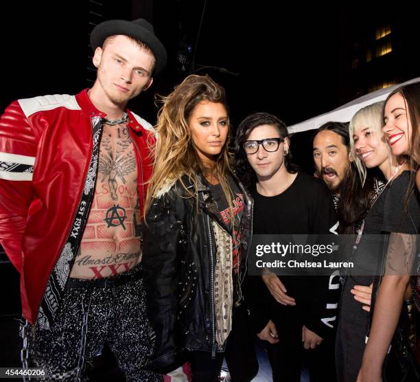 Rapper Machine Gun Kelly, singer Moxie Raia, DJ Skrillex, DJ Steve Aoki and DJ Mija pose backstage during day 2 of the Made in America Festival at...