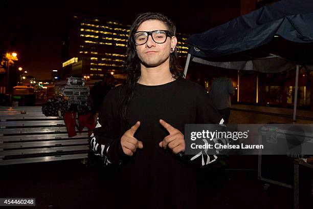 Skrillex poses backstage during day 2 of the Made in America Festival at Los Angeles Grand Park on August 31, 2014 in Los Angeles, California.