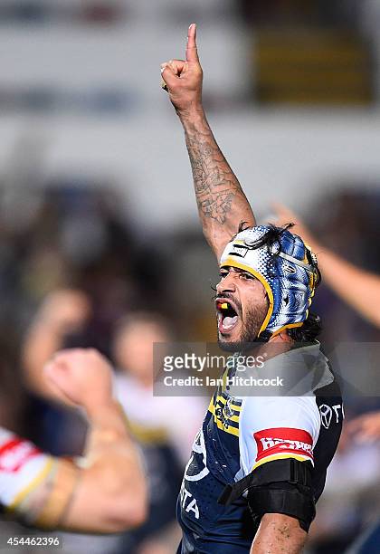Johnathan Thurston of the Cowboys celebrates after kicking the winning field goal during the round 25 NRL match between the North Queensland Cowboys...