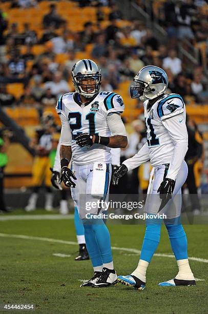 Safety Thomas DeCoud of the Carolina Panthers talks to safety Roman Harper during a preseason game against the Pittsburgh Steelers at Heinz Field on...