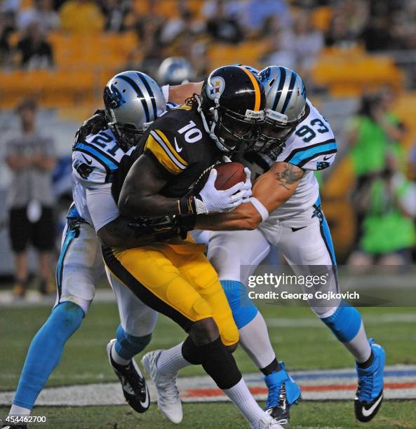 Wide receiver Martavis Bryant of the Pittsburgh Steelers is tackled by safety Thomas DeCoud and linebacker Chase Blackburn of the Carolina Panthers...