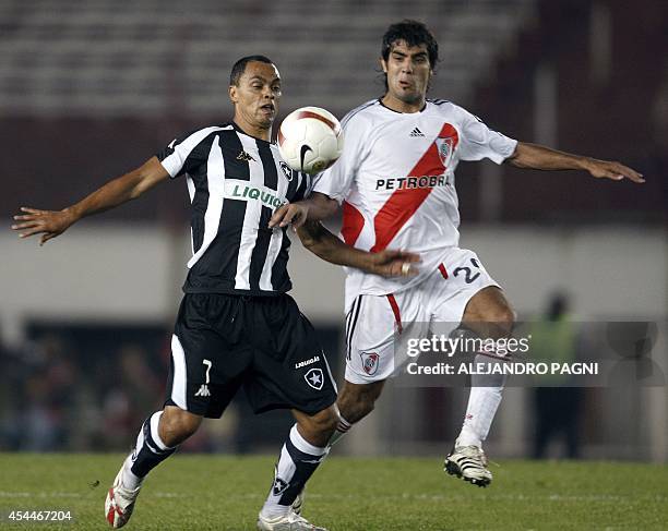 Brazilian Botafogo's forward Dodo vies for the ball with midfielder Augusto Fernandez of Argentina's River Plate, during their Copa Sudamericana...