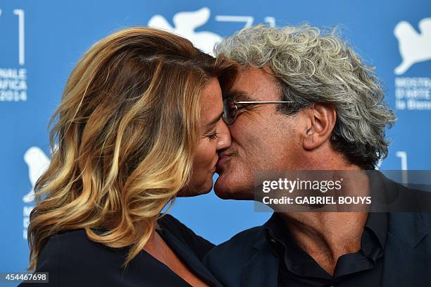 Italian director Mario Martone kisses screenwriter Ippolita Di Majo during the photocall of the movie "Il Giovane Favoloso" presented in competition...