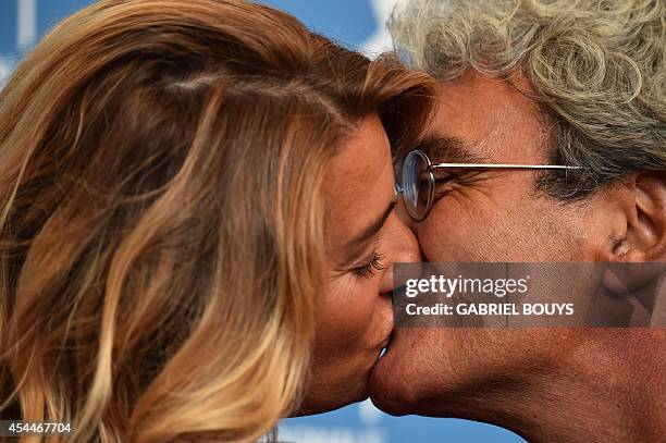 Italian director Mario Martone kisses screenwriter Ippolita Di Majo during the photocall of the movie "Il Giovane Favoloso" presented in competition...