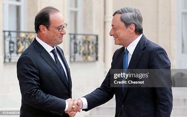 French president Francois Hollande welcomes President of the European Central Bank Mario Draghi, prior their meeting at the Elysee palace on...