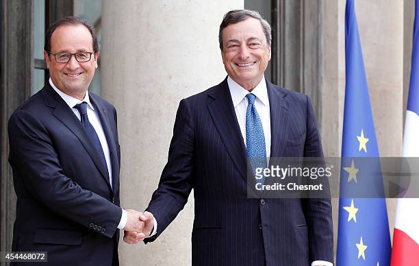 French president Francois Hollande welcomes President of the European Central Bank Mario Draghi, prior their meeting at the Elysee palace on...