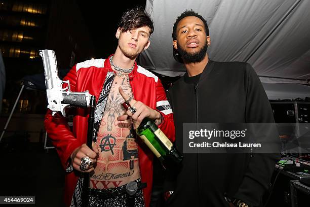 Rapper Machine Gun Kelly and Slim Gudz pose backstage during day 2 of the Made in America Festival at Los Angeles Grand Park on August 31, 2014 in...